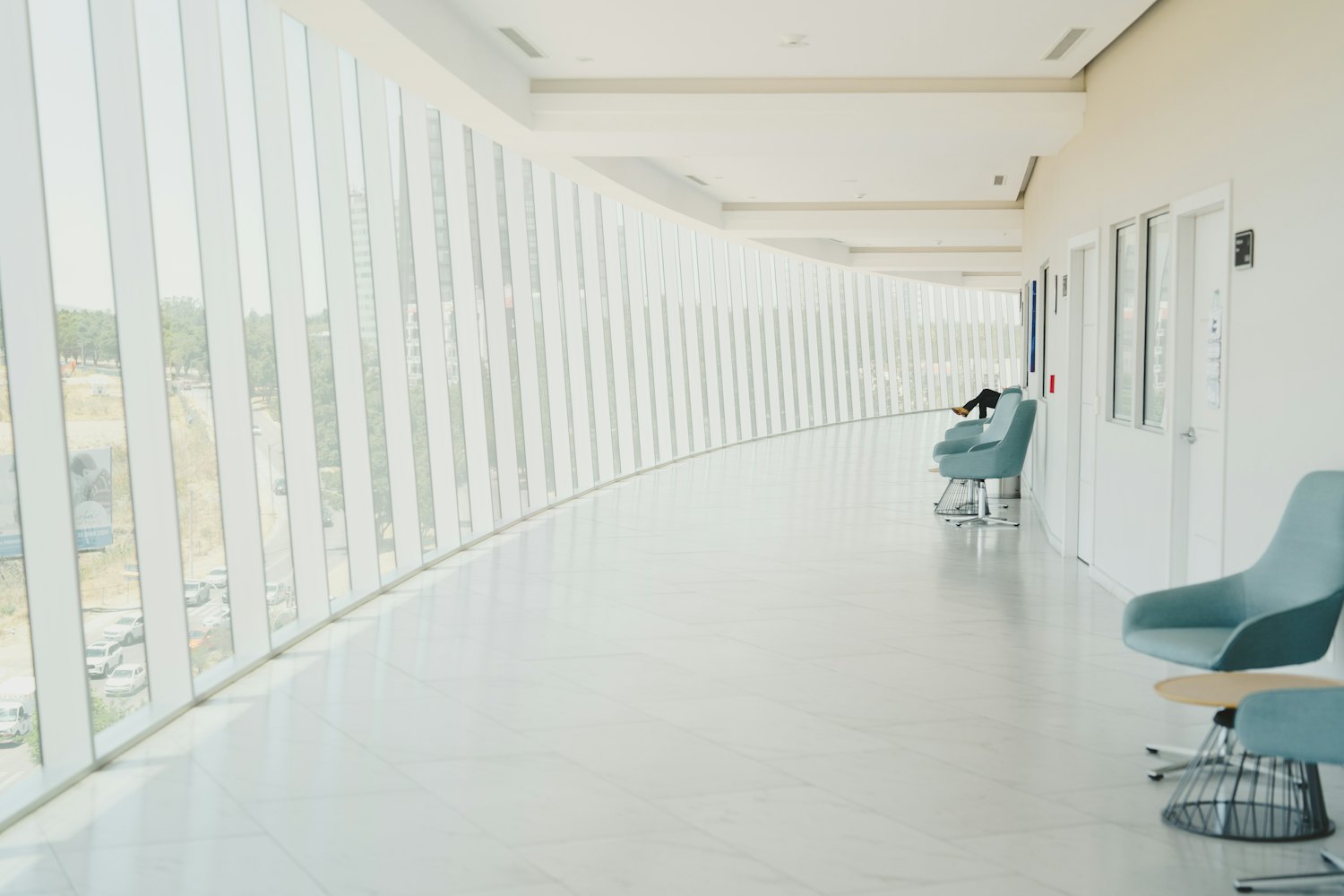 A bright, modern clinic corridor with large windows